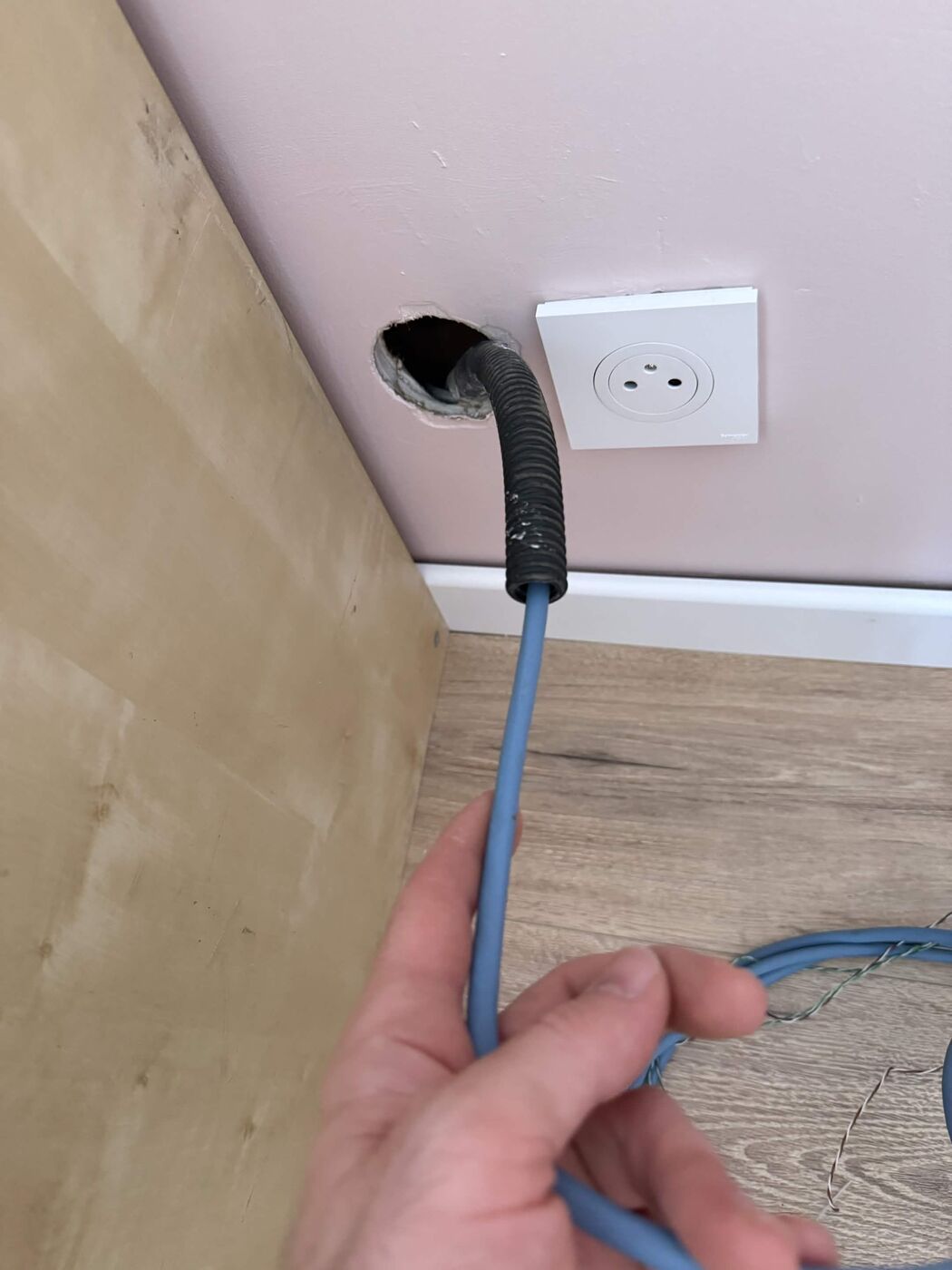 Category 6 internet cable installation coming out of the wall, ready to be connected to an RJ45 wall socket